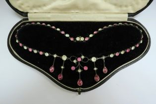A paste set necklace with pink and clear stones in fitted case