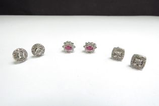 Two pairs of diamond chip earrings stamped 925 and a pair of ruby and clear stone examples