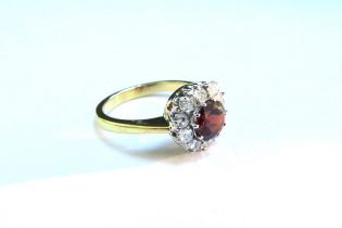 An 18ct gold garnet and diamond cluster ring. Size N/O, 4.1g