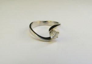 A white gold diamond solitaire ring the 0.50ct approx diamond in crossover setting, marked 750. Size