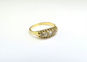 A gold five stone diamond ring, stamped 18ct. Size M, 2.6g