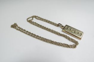 A 9ct gold 1/2oz ingot hung on a 9ct gold chain, 56cm long, 22.6g