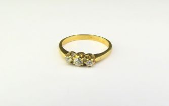 A three stone diamond ring, stamped 18ct. Size O, 2.8g