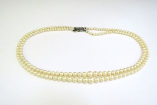 A double strand cultured pearl necklace, circa 1930, clasp stamped 9ct, 46cm long, boxed