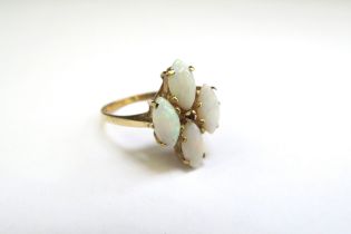 A 9ct gold four stone opal and small ruby set ring. Size M, 2.7g