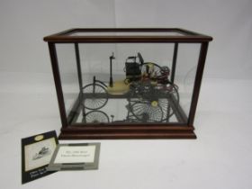 A Franklin Mint 1:8 scale 1886 Benz Patent Motorwagen, housed in glass display case