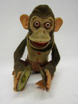A Kuramochi (Japan) fabric covered tinplate battery operated clapping monkey with cymbals, 23cm tall