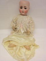 An Alt Beck & Gottschalk 1362 bisque head girl doll with brown glass sleepy eyes, painted