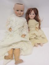Two early 20th Century bisque head dolls on articulated composition bodies, to include Armand