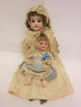 Two erly 20th Century bisque head dolls to include Trebor 22 socket head doll on articulated