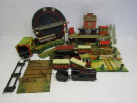 A collection of playworn 0 gauge model railway rolling stock, accessories and spares including Wells