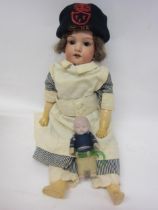 An Armand Marseille WWI nurse character doll, bisque head with sleepy brown glass eyes, open mouth