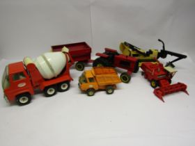 Four Tonka pressed steel vehicles to include tractor with trailer, cement mixer, tipper truck and