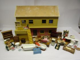 A wooden dolls house (for restoration) and assorted furniture and accessories