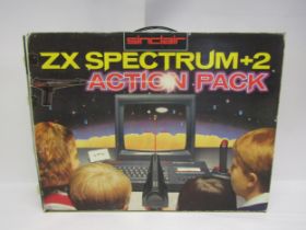 A boxed Sinclair ZX Spectrum +2 Action Pack vintage computer gaming console including light gun,