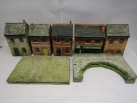 Four weathered garden railway plastic model lineside buildings, each approx 32cm tall, together with