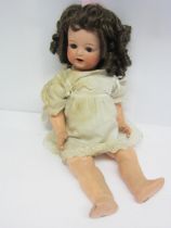 An Armand Marseille for Koppelsdorf bisque head girl doll with brown ringlet wig, brown glass sleepy