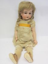 An early 20th Century Armand Marseille bisque head girl doll with blonde ringlet wig, blue glass
