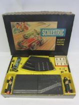 A boxed 1960s Triang Scalextric Model No.1 slot racing set, comprising two green tinplate number '7'
