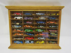 A collectors wall mounting display cabinet (34.5cm x 44.5cm) housing a collection of thirty-two