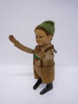 A Schuco clockwork tinplate figure of a Tyrolean boy in felt outfit, arms move when wound, 13cm tall