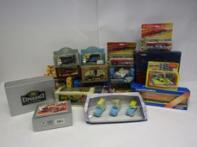 A collection of boxed/cased diecast vehicles and sets including Corgi LR1002 Land Rover Defender and
