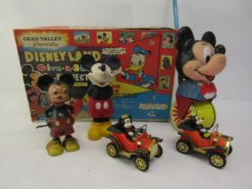 A collection of vintage Mickey Mouse toys to include two Masudaya tinplate cars, Marx Hong Kong made
