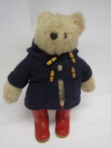 A vintage Gabrielle Designs Paddington Bear in original dark blue duffle coat and red wellington