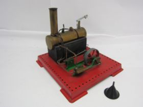 A Mamod live steam stationary engine, the brass horizontal boiler powering twin cylinder and