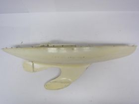A white painted tinplate pond yacht with weighted keel, 61cm long