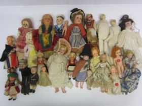 A collection of assorted character and costume dolls including bisque, plastic, celluloid and felt