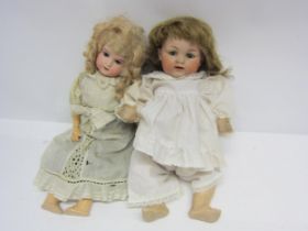 Two early 20th Century Armand Marseille bisque head dolls, each with striated blue glass eyes,