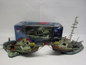A boxed McFarlane Toys Jaws Deluxe Boxed Set model depicting great white shark attacking boat (box