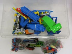 A Tomy plastic train set with two battery operated locomotives and a quantity of Thomas and