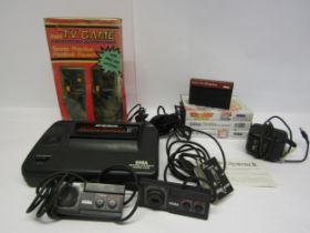 An unboxed Sega Master System II vintage computer games console with two control pads, power supply,