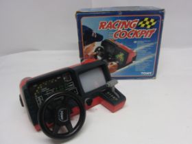 A boxed 1980s Tomy Racing Cockpit battery operated driving game, no. 7057 SP