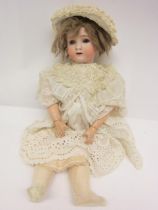 An Alt Beck & Gottschalk 1362 bisque head girl doll with mousey brown wig, striated blue glass eyes,