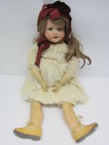 A Heubach Koppelsdorf bisque head girl doll with blonde wig, brown glass sleepy eyes, painted brows,