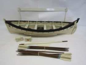 A scale model of Lifeboat no.14 from RMS Titanic, with ten oars, mast, two water barrels, rations