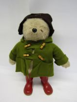 A vintage Gabrielle Designs Paddington Bear in original green duffle coat, brown hat and red