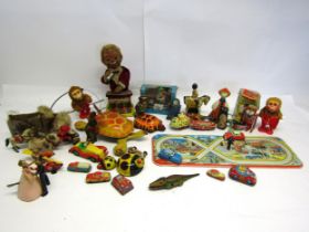 A collection of mostly playworn tinplate and mechanical novelty toys and vehicles including