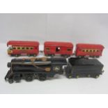 A playworn American Flyer 401 0 gauge electric 2-4-4 locomotive, tender and three coaches (loco