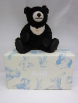 A boxed Steiff 'Moon Ted' teddy bear no. 036491, the dark brown mohair bear with cream chest and