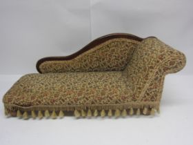 A Victorian style dolls chaise longue with floral tapestry upholstery, 65cm long x 28cm tall
