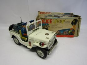 A Nomura TN (Japan) battery operated tinplate Police Jeep, the white Jeep with folding windscreen,