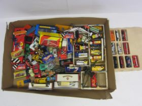 A collection of assorted boxed and loose diecast vehicles and accessories including boxed Matchbox