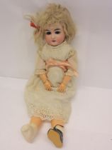 An early 20th Century Armand Marseille bisque head girl doll with blonde wig, striated blue glass
