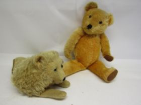 A straw filled golden mohair teddy bear with glass eyes, stitched nose and mouth and articulated