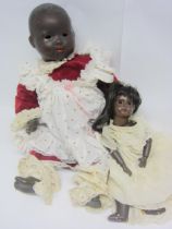 Two black bisque head dolls to include Armand Marseille 351 baby, 60cm tall, and smaller girl