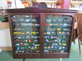 An Edwardian mahogany glazed display case with glass shelved interior, housing a collection of